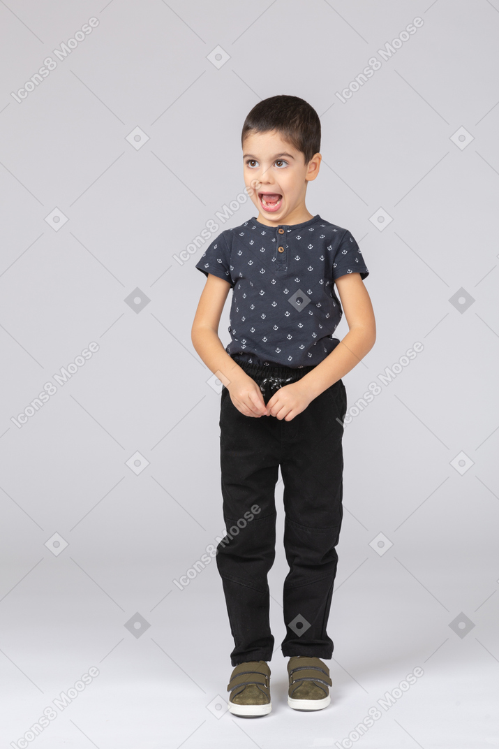 Front view of a cute boy standing with open mouth