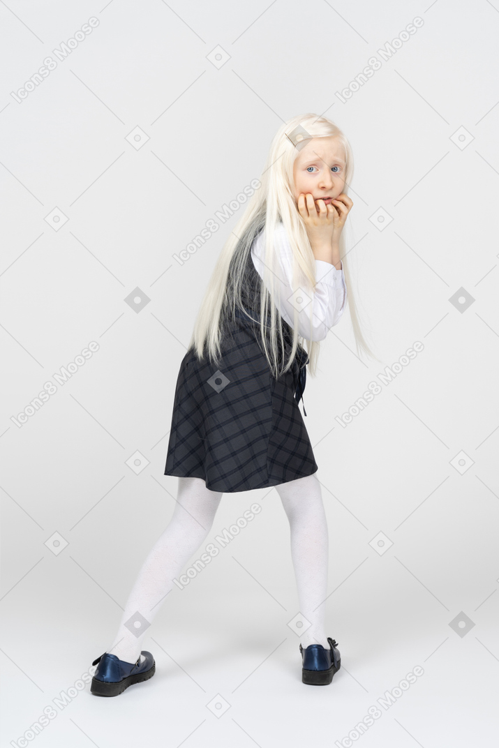 Schoolgirl turning around, looking afraid