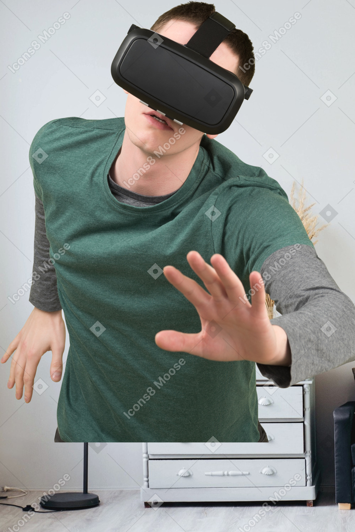 A young man wearing a virtual reality headset