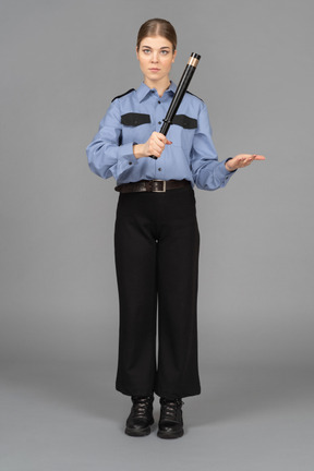 Female security guard with a baton in hands