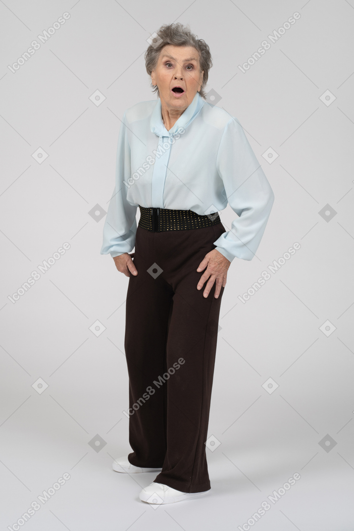 Front view of an old woman looking scared and shocked
