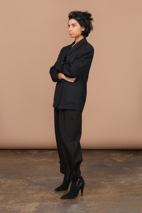 Three-quarter view of a pouting businesswoman dressed in black suit