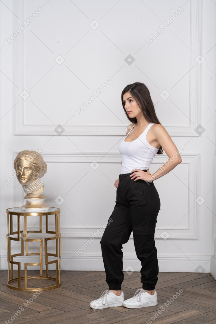 Young woman looking serious with hands on waist