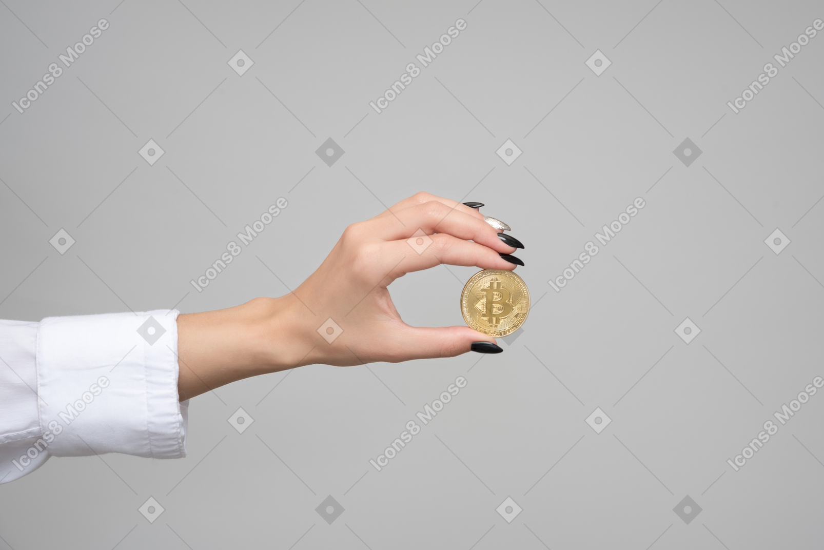 Female hand holding a golden bitcoin