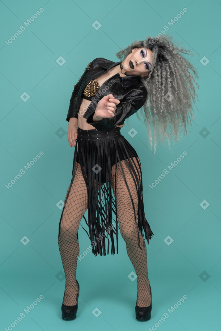 Drag queen with hand reaching out and head tilted