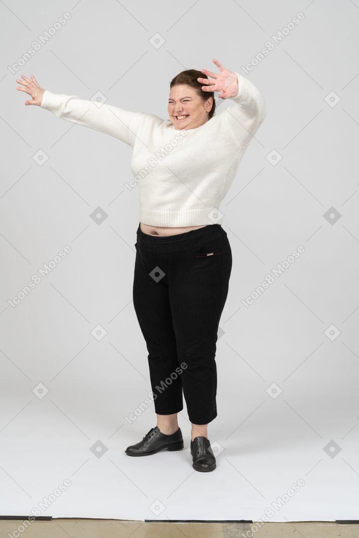 Cheerful plump woman in white sweater