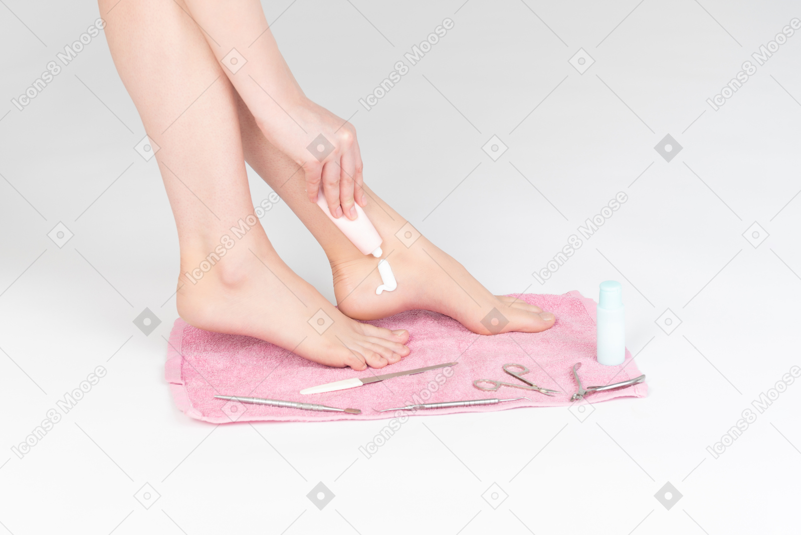 Shot of female legs and woman applying cream