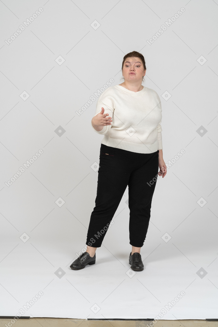 Front view of a plus size woman in casual clothes posing