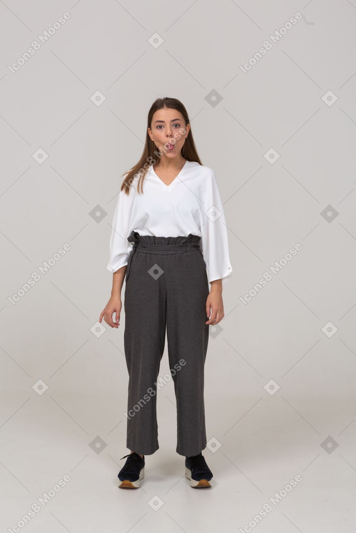 Front view of a young lady in office clothing showing tongue