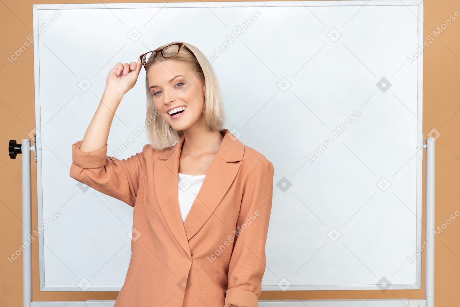 Beautiful young teacher in terracotta jacket taking her glasses off
