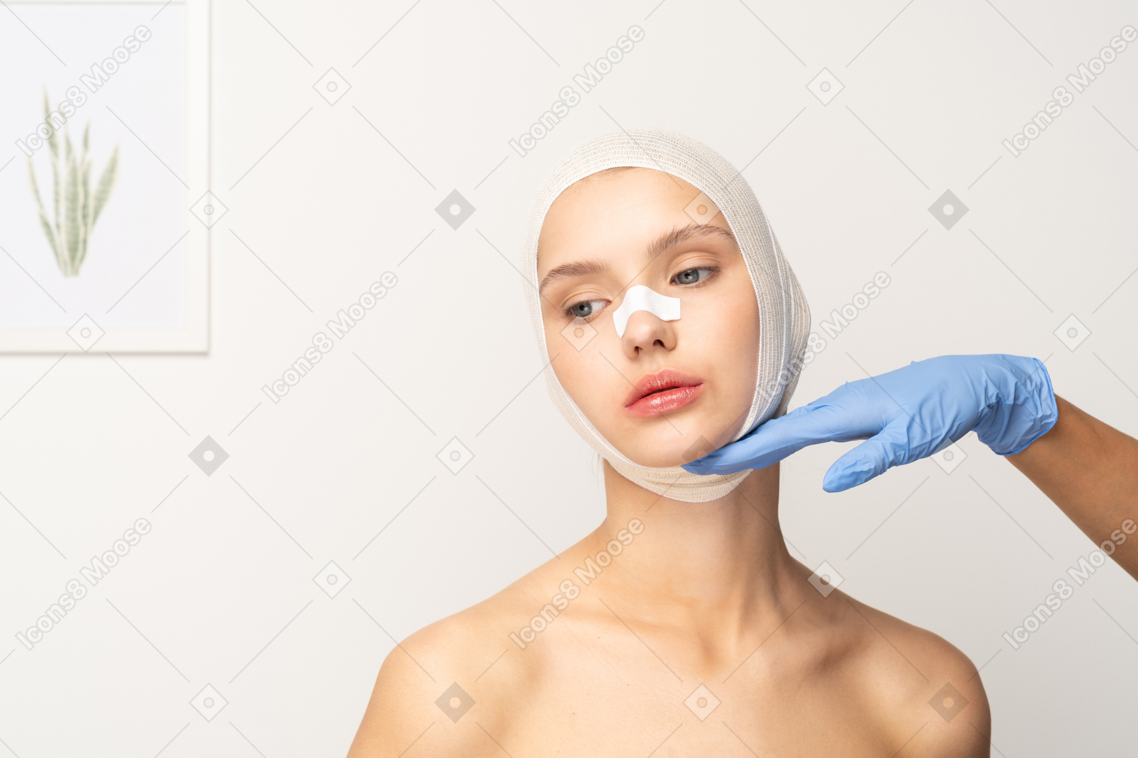 Female patient with gloved hand touching her chin