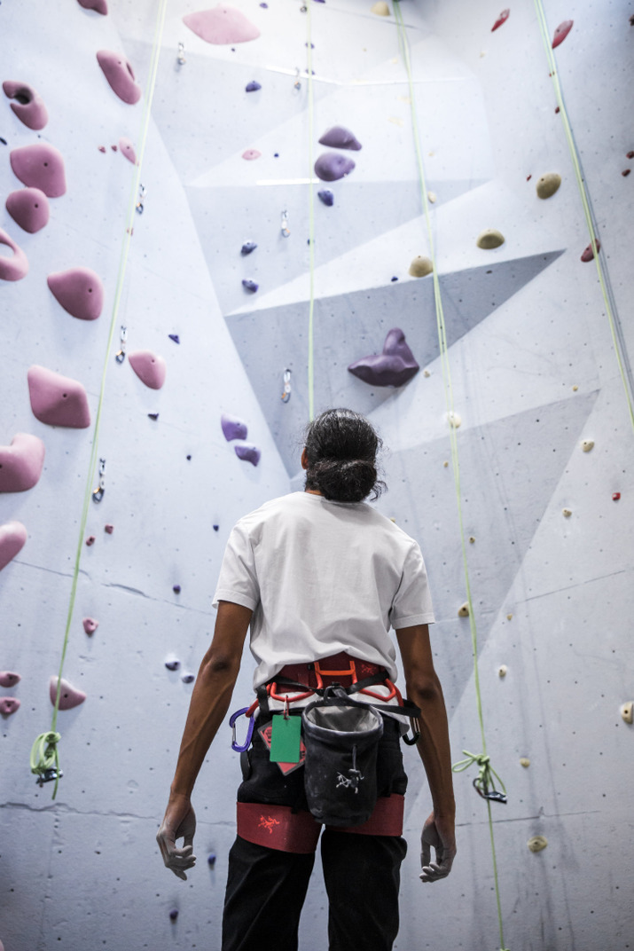 Man preparing to climb up at an indoor climbing centre
