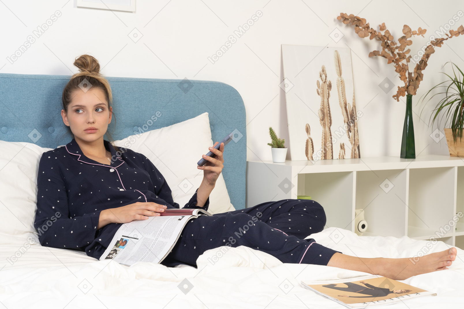 Full-length of a young female in pajama laying in bed while surfing the net