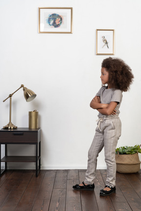 Good looking girl kid posing on the apartment background