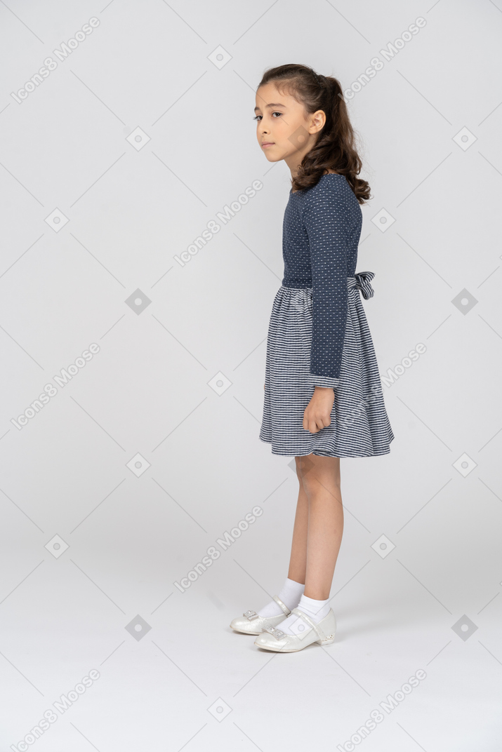 Side view of a girl peering to the side carefully