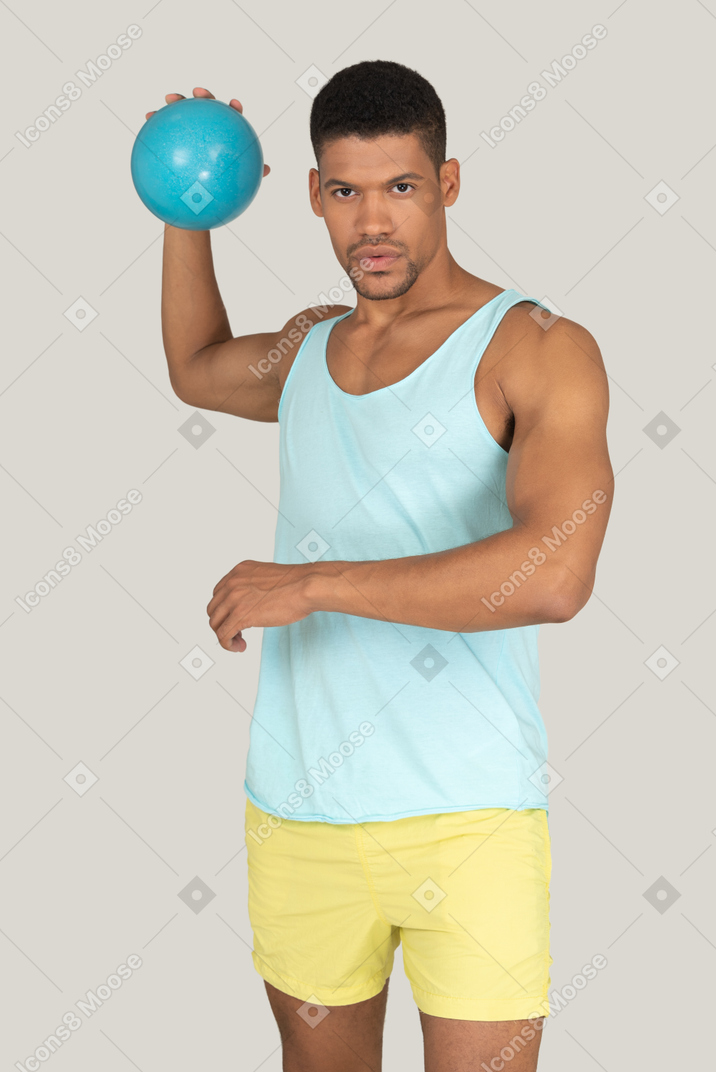 A man holding a blue ball in his right hand
