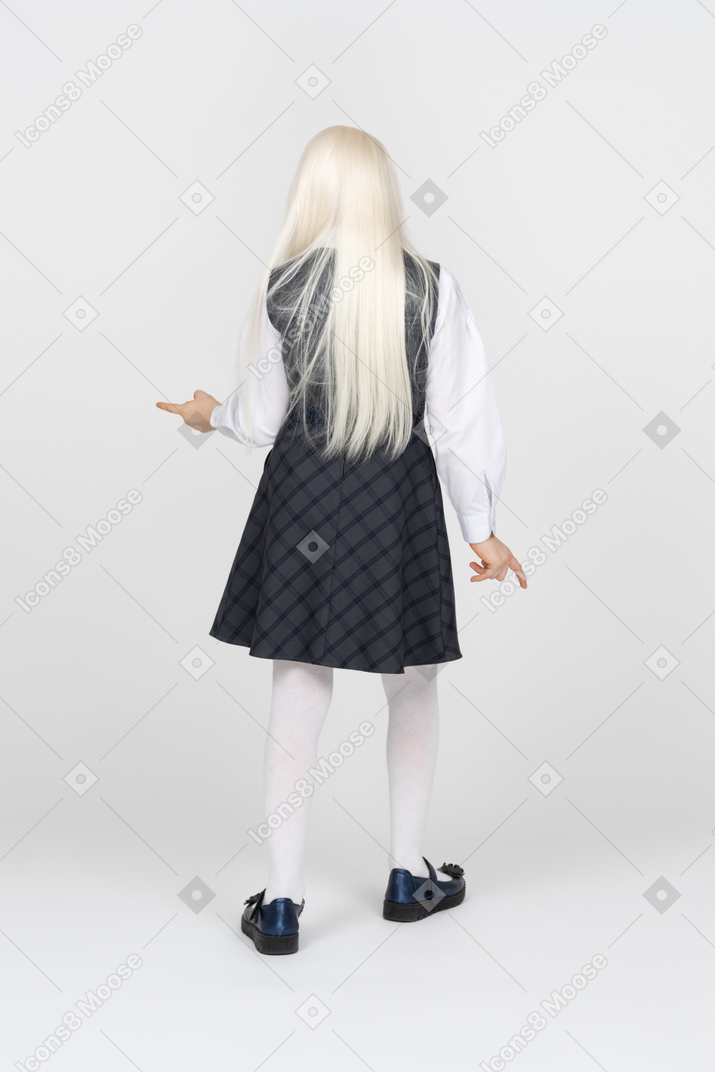 Back view of a schoolgirl pointing in different directions