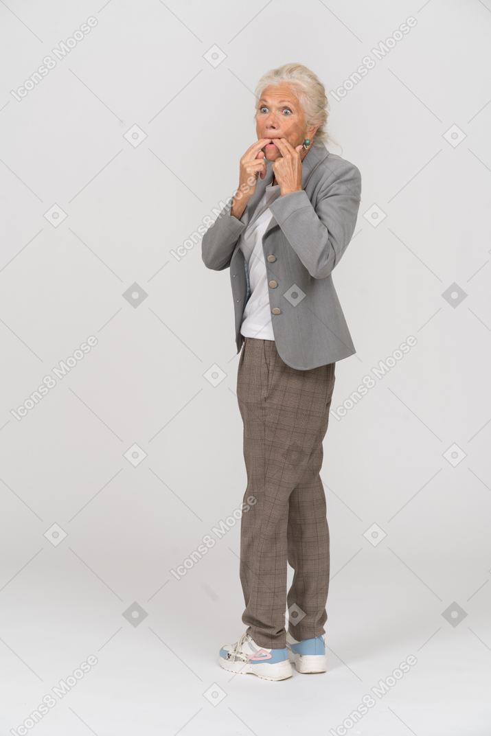 Side view of an old lady in suit whistling