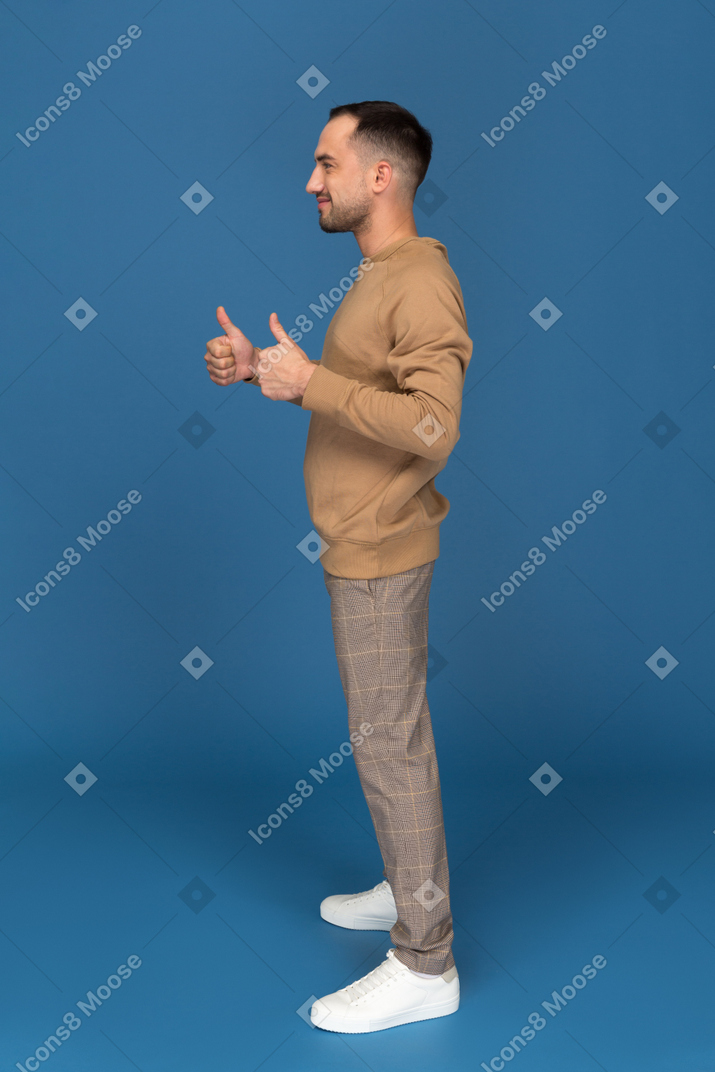 Young man showing thumbs up