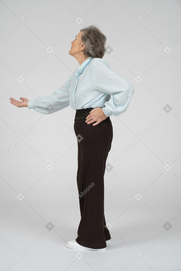 Side view of an old woman stretching out her hand begging