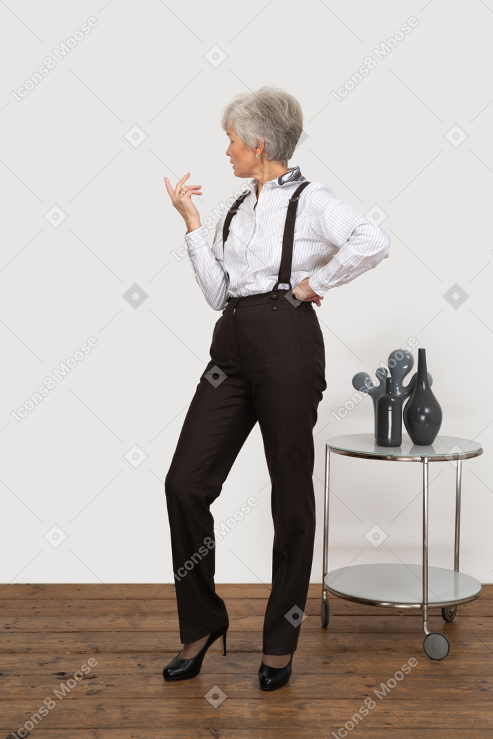Front view of a thoughtful gesticulating lady in office clothing