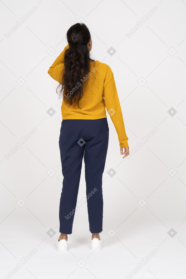 Rear view of a girl in casual clothes standing with hand on head