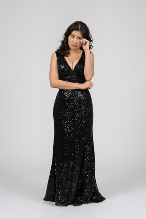 Upset woman wearing black evening dress