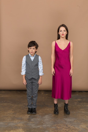 Front view of a boy in suit vest and young woman