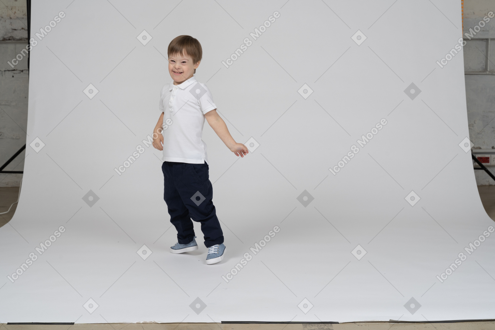 Happy boy standing and stretching his arms