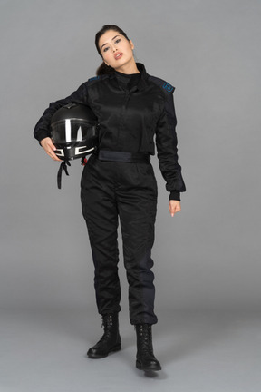 A self-confident young woman posing with a helmet