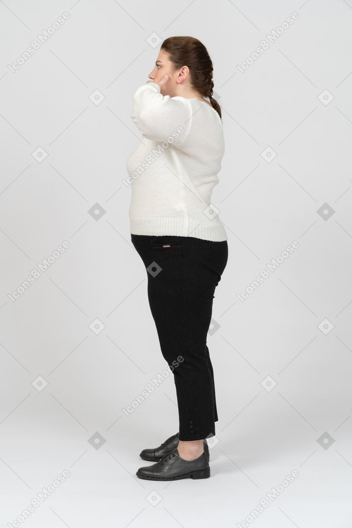 Plump woman in casual clothes making faces