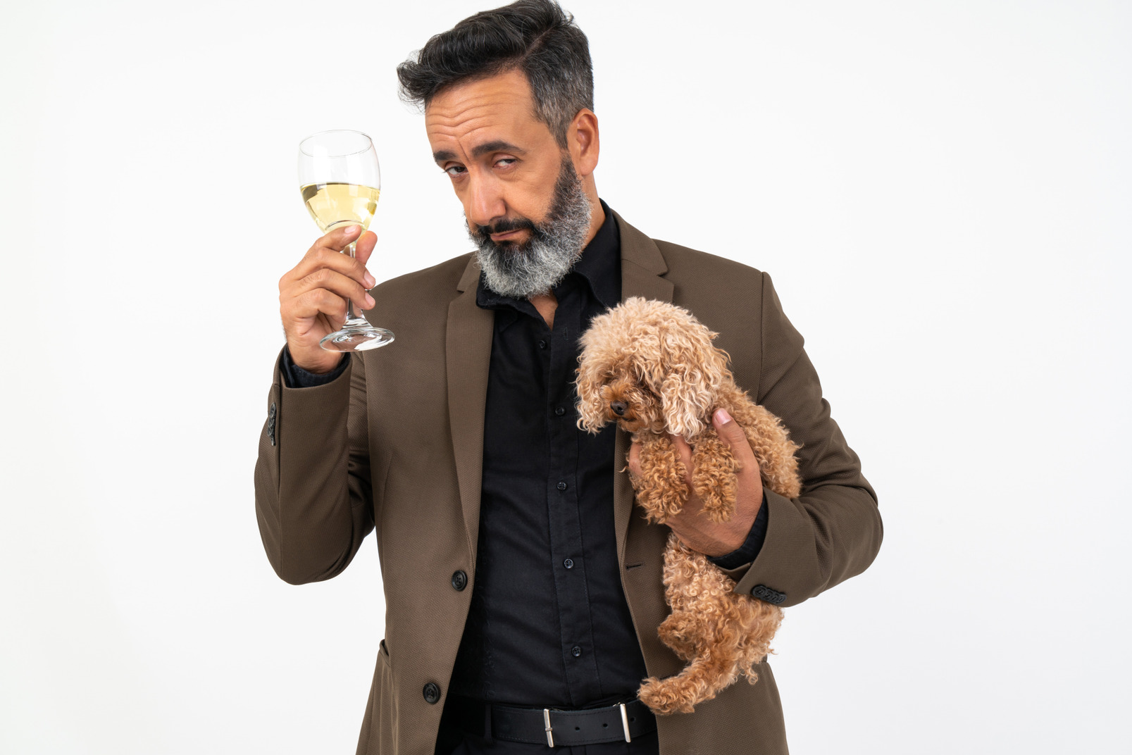 Handsome man with a puppy holding a glass of wine