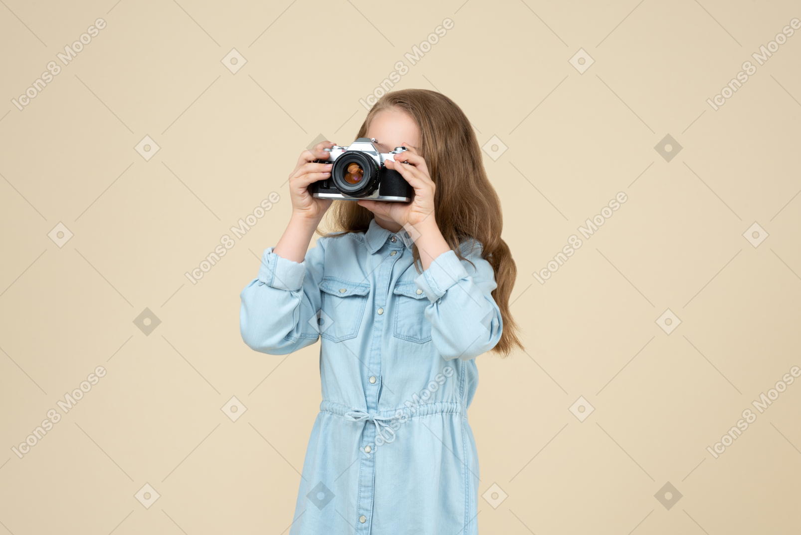 Bambina carina che tiene una macchina fotografica
