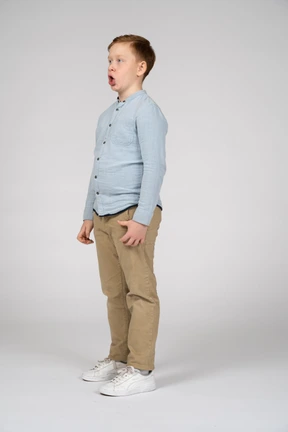Cute boy in casual clothes making faces