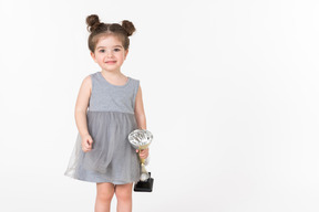 Little girl holding an award cup