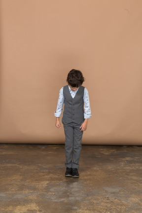 Front view of a boy in suit looking down