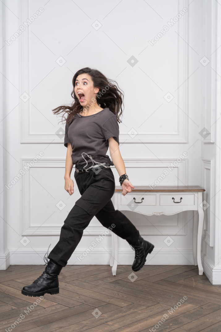 Three-quarter view of a screaming jumping female rocker