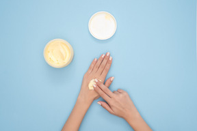 Applying nourishing cream to hands