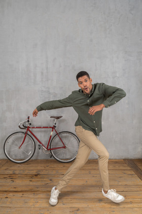 Three-quarter view of a man jumping and spinning around