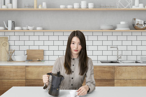 A woman sitting at a table with a coffee cup