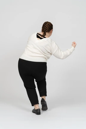 Rear view of a plump woman in casual clothes