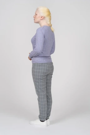 Young woman standing and holding her hands in front