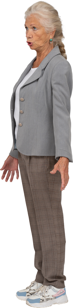 Emotional old lady in suit standing in profile