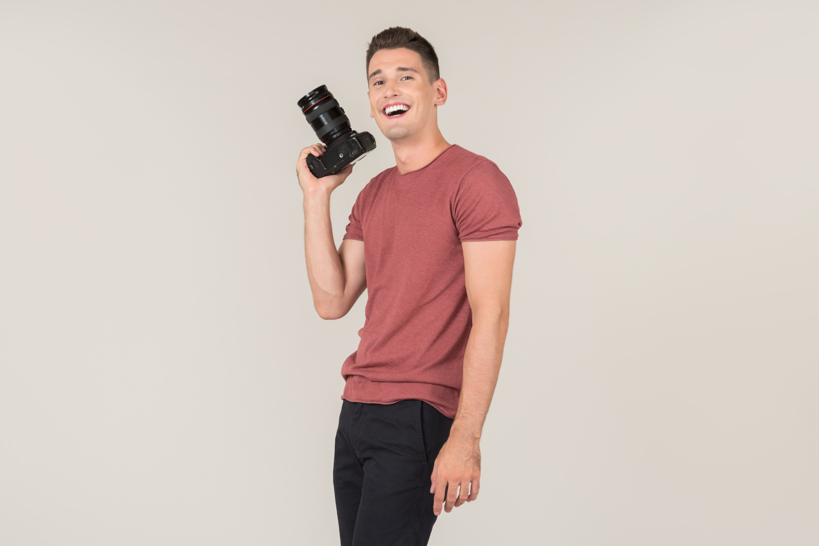 Young guy holding a photo camera