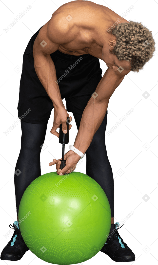 Vista frontal de un hombre afro sin camisa inflando una pelota de gimnasia