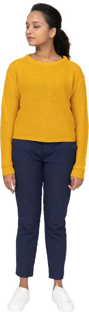 Front view of a girl in casual clothes standing with closed eyes