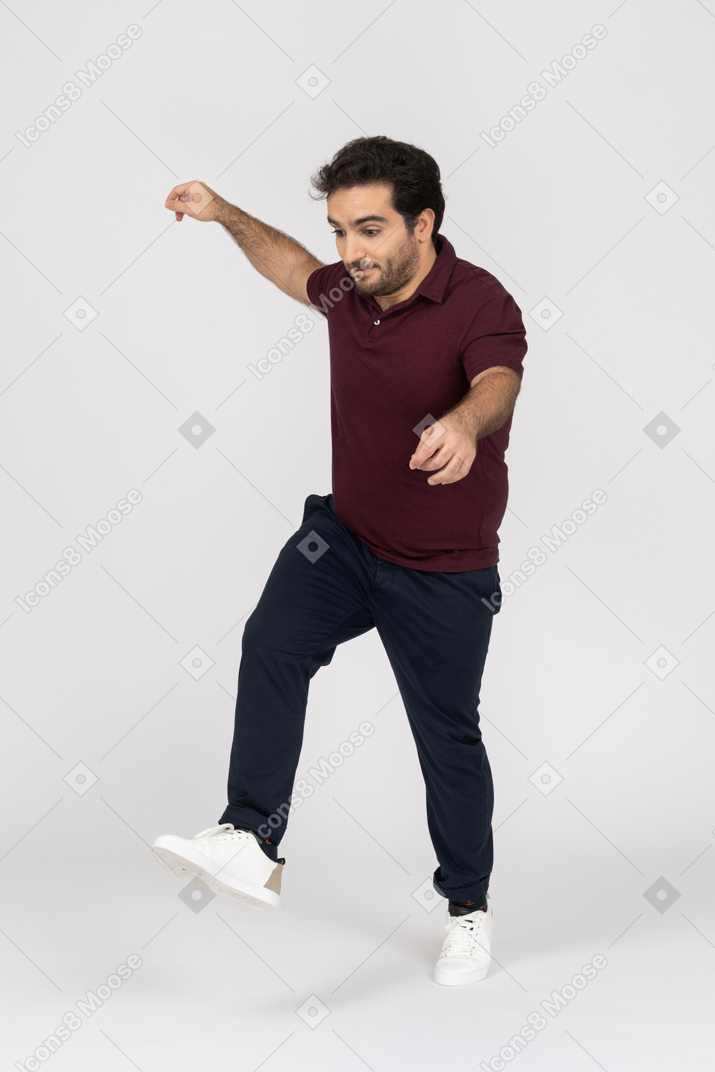 Man in casual clothes kicking his foot