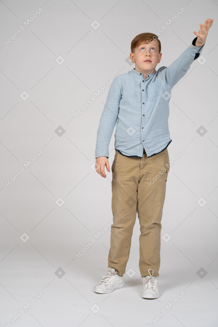 Front view of a boy pointing up with hand