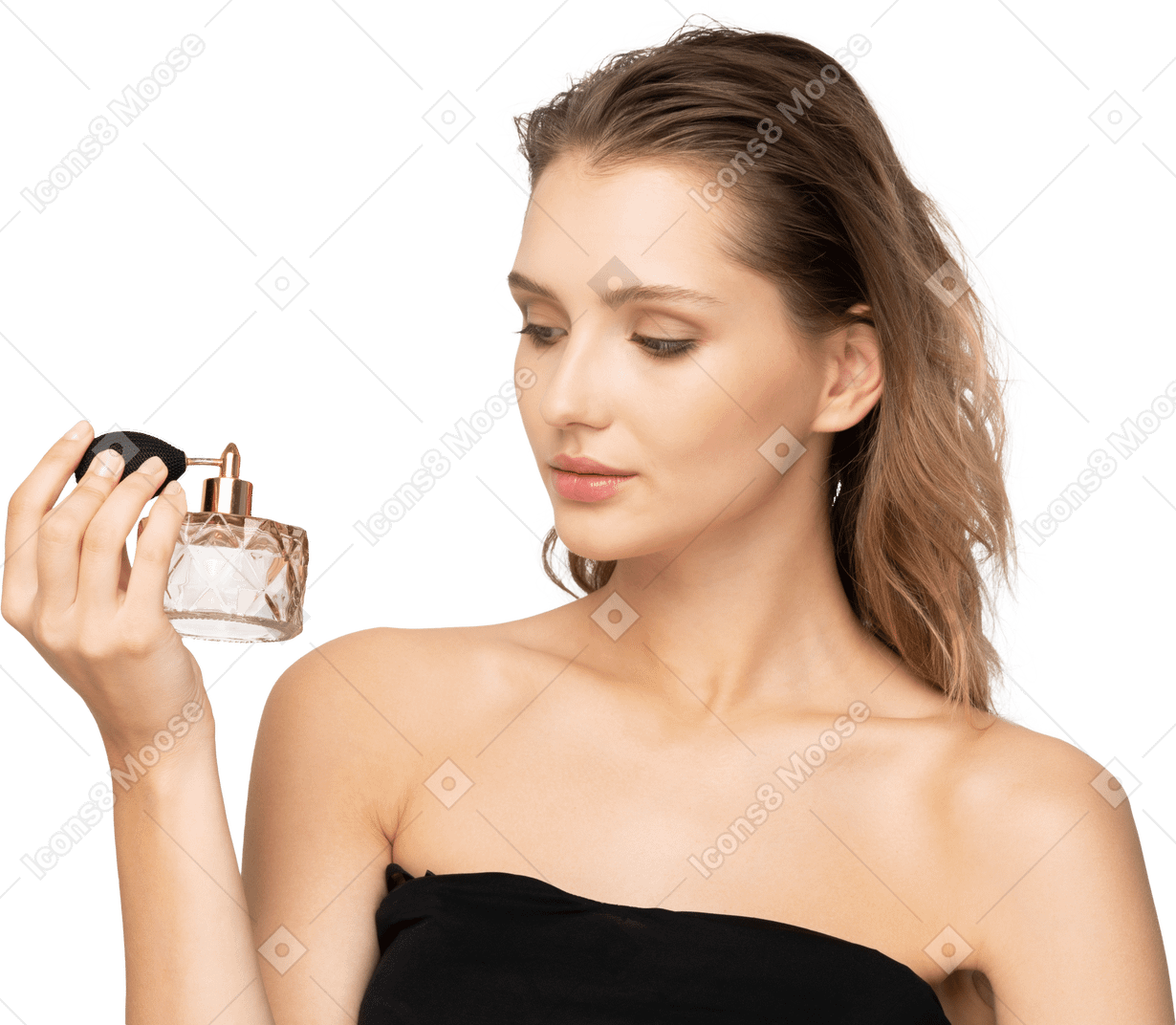 Front view of a sensual young woman holding a bottle of perfume