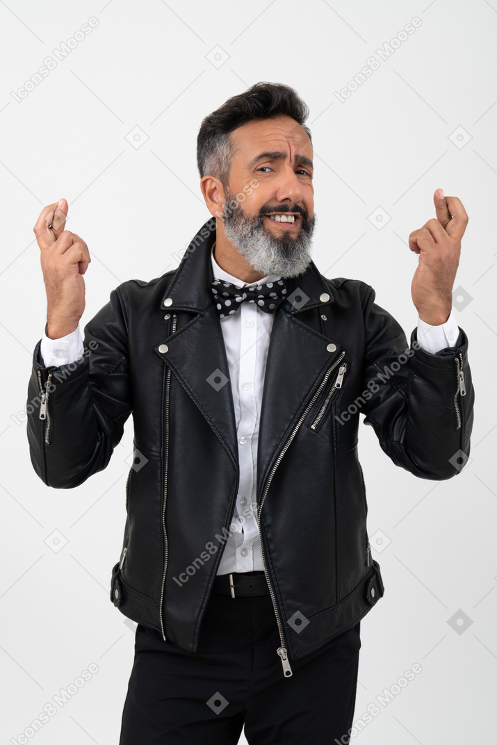 Thrilled mature man holding his fingers crossed